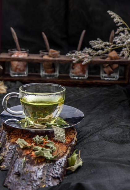 A Cup of pandan leaf tea, indian marsh fleabane plant leaves with Safflower dried (Saffron substitute) at dark background. A Cup of pandan leaf tea, indian marsh fleabane plant leaves with Safflower dried (Saffron substitute) at dark background. Thai herbal plant and healthy drinks concept. Selective focus. substitute for saffron stock pictures, royalty-free photos & images