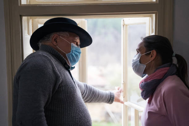 istock Coronavirus protection. Active senior man with his daughter ltalking about the coronavirus. Wearing masks to avoid infectious diseases while at home during the quarantine. 1214376403