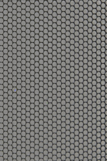 istock Metal background with round holes perforation, net of circles texture 1214377608