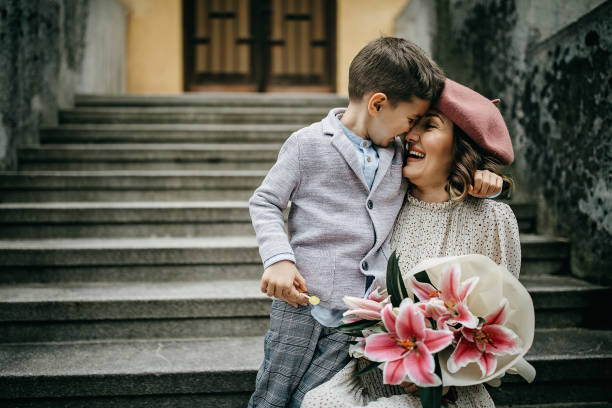 istock Son gifting flowers to her mother 1214378274