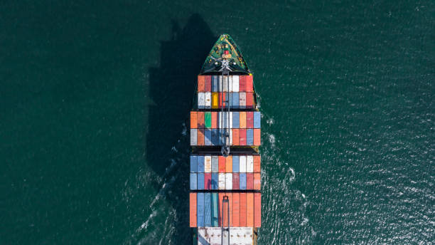 istock Aerial view container ship carrying container box global business cargo freight shipping commercial trade logistic and transportation oversea worldwide  by container vessel.Container cargo freight ship. 1214382236