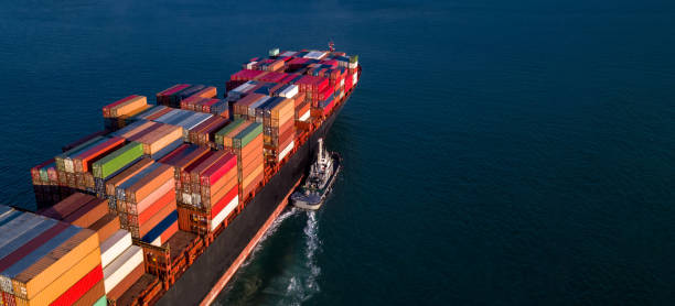 istock Container cargo ship business commercial trade import export logistic transportation container box oversea worldwide by container vessel boat freight shipping maritime with tugboat. 1214382240
