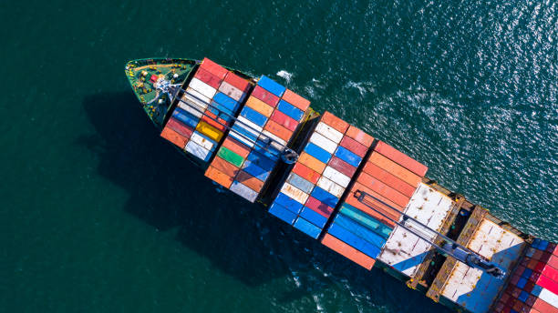 istock Aerial view container ship carrying container box global business cargo freight shipping commercial trade logistic and transportation oversea worldwide  by container vessel.Container cargo freight ship. 1214382241