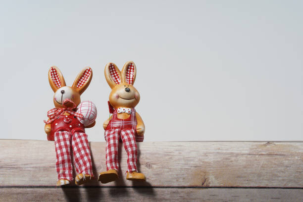 istock Bunny boy bunny girl sitting next to each other. Easter concept. Empty space for design. 1214384154