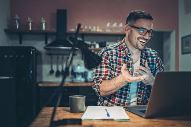 istock Smiling man in a video call from his home 1214385234