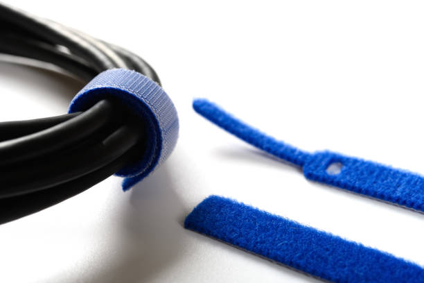 blue velcro cable tie and cable on white blue velcro cable tie and cable on white nylon fastening tape stock pictures, royalty-free photos & images