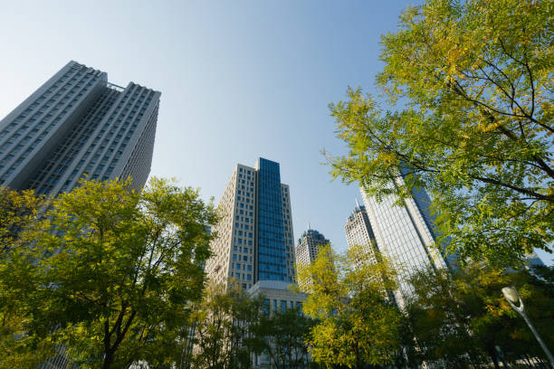 istock Business towers and Green leaves 1214386080