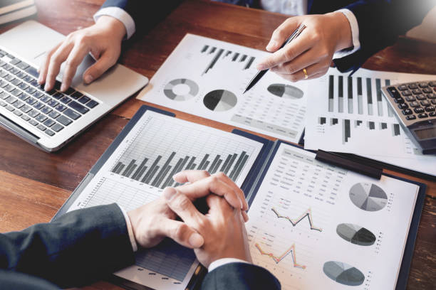 istock Business Corporate team brainstorming, Planning Strategy having a discussion Analysis investment researching with chart at office his desk documents and saving concept. 1214386180
