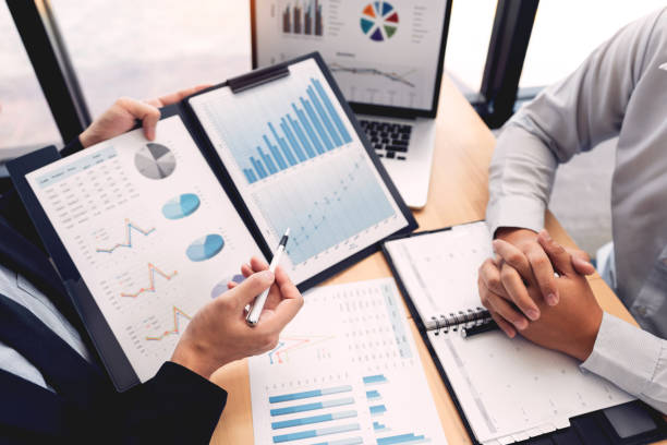 istock Business Corporate team brainstorming, Planning Strategy having a discussion Analysis investment researching with chart at office his desk documents and saving concept. 1214386239