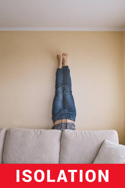 istock Man handstanding behind couch. People goes crazy in quarantine. 1214387071