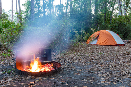 A small campfire roars in a remote campsite in Georgia's Okefenokee Swamp.