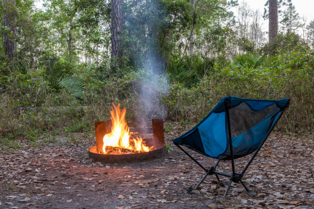 istock Chair Next to Blazing Campfire 1214388151