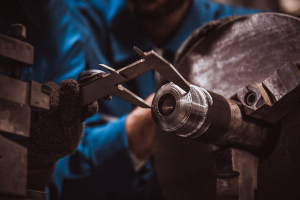 istock The Industry engineering wearing safety uniform used Vernier caliper to measure the object control working in industry factory. 1214390632
