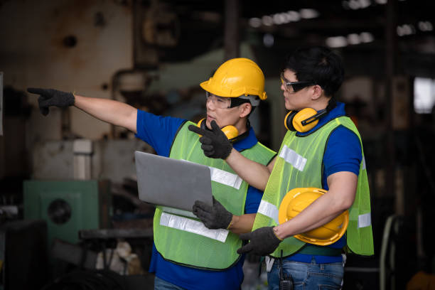istock Industry engineer under inspection and checking production process on factory station by laptop,Engineer wearing casual uniform and safety helmet in work. 1214391520