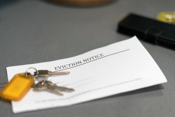 House Keys and Eviction Notice House keys sitting on an eviction notice received in the mail. eviction photos stock pictures, royalty-free photos & images