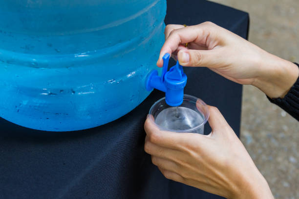 istock Female hand holding water glass 1214392978