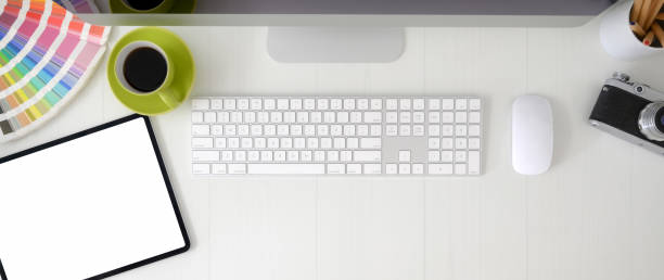 istock Overhead shot of graphic designer workspace with blank screen tablet, computer device and designer supplies 1214397502