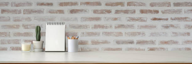 istock Cropped shot of minimal workspace with mock-up calendar, decorations and copy space 1214397524