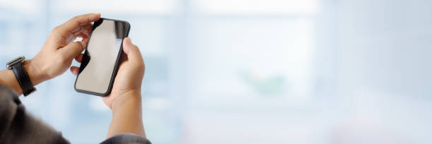 istock Cropped shot of a man holding smartphone on blurred background 1214397585