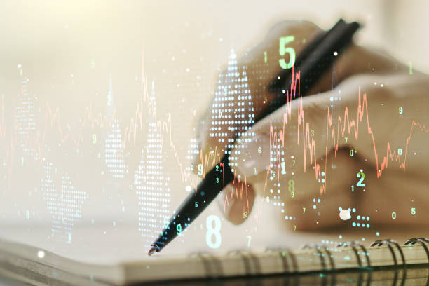 istock Double exposure of abstract creative financial chart with hand writing in notebook on background, research and strategy concept 1214397818