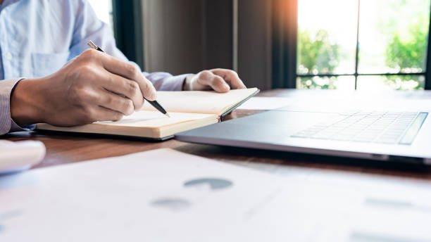 istock strategy analysis concept, Businessman working  financial Manager Researching Process accounting calculate analyse market graph data stock information review on the table in office. 1214400728