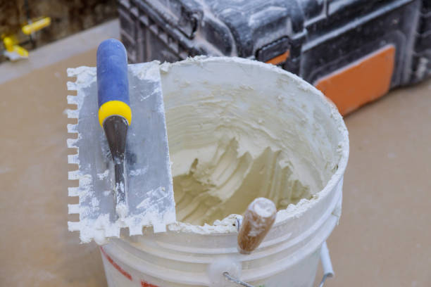istock Trowel mortar tIling a closeup with trowel ceramic tiles. 1214402306