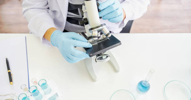 istock Asian Female scientist analyzing sample in laboratory. Medical professional is experimenting. 1214402993