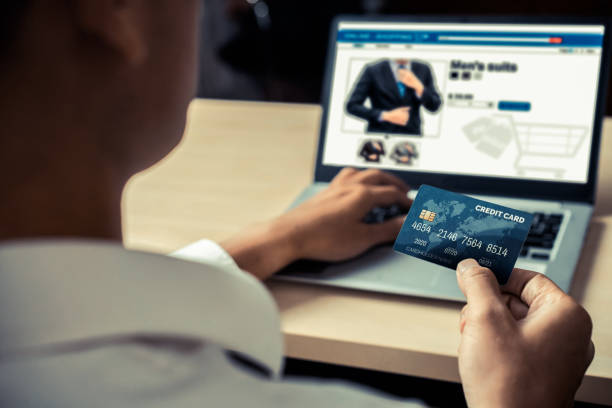 istock Young man use credit card for online shopping 1214405561