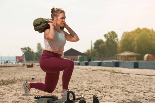 Sporty woman training at the beach.