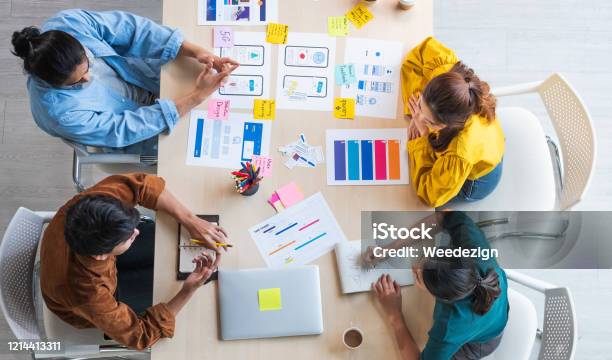 Top View Ux Developer And Ui Designer Brainstorming About Mobile App Interface Wireframe Design On Table With Customer Breif And Color Code At Modern Officecreative Digital Development Agency Stock Photo - Download Image Now