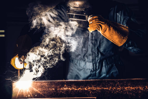 istock Metal welder working with arc welding machine. 1214415457
