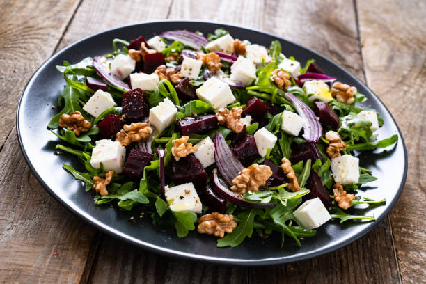 istock Beetroot salad with goat cheese on wooden background 1214416489