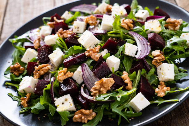 istock Beetroot salad with goat cheese on wooden background 1214416519