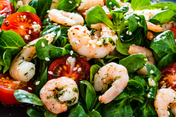 istock Prawns with vegetables on wooden table 1214417376
