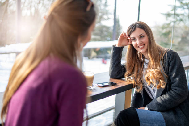 istock Two Women Sitting In Coffee Shop 1214418212