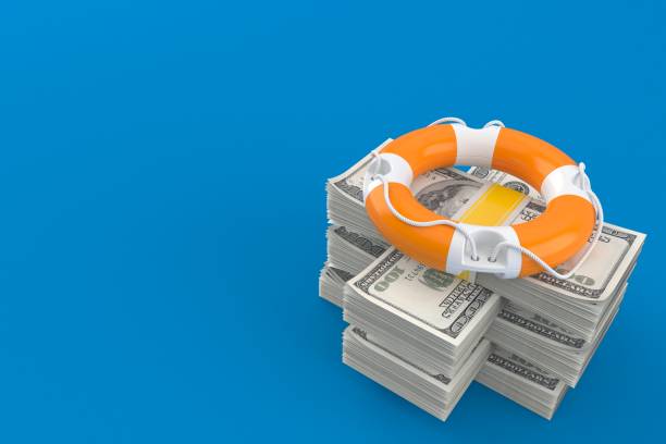 istock Life buoy on stack of money 1214418233