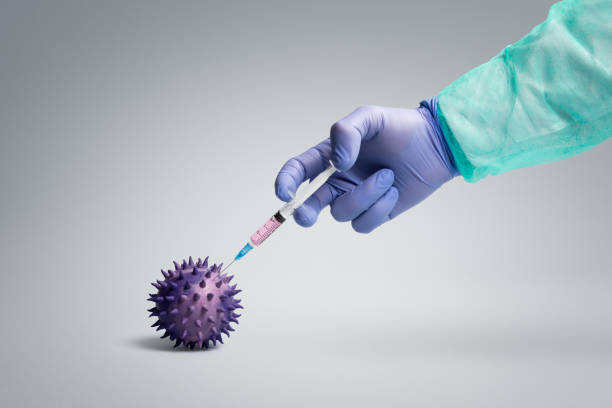 Vaccine Health worker  injecting vaccine into a pathogen like viruses and bacteria illness prevention photos stock pictures, royalty-free photos & images