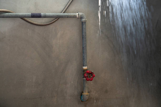istock Water pipe and valve on Cement wall in Shower room. 1214419594