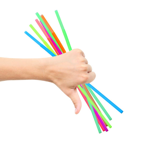 istock Plastic multicolored straws in hand, sign