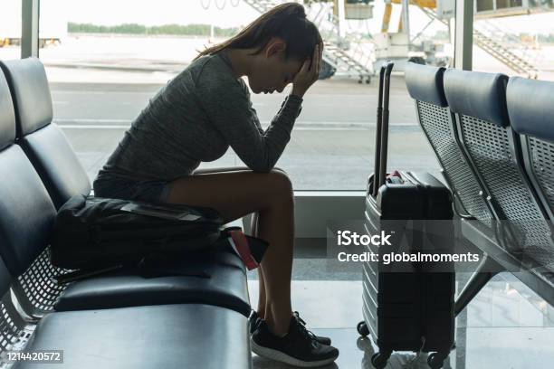 A Passenger Waiting At The Airport Terminal Stressed Out At Tired Stock Photo - Download Image Now