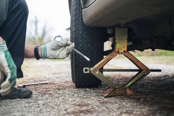 istock Changing car tire on a country road. DIY 1214422063