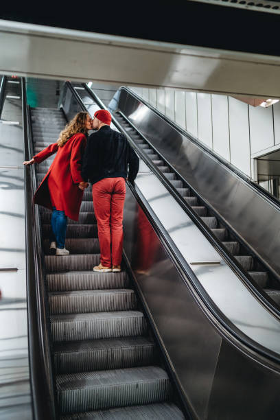 Couple in love on subway escalator