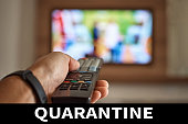 Stay home for covid-19 coronavirus protect. Man watching TV with  remote control in his hand and inscription quarantine. Entertaiment for people during home quarantine