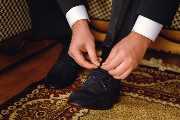 istock stylish elegant groom getting dressed in the morning for a wedding 1214426857