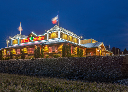 New Hartford, New York - Mar 19, 2020: Night View of Texas Roadhouse Restaurant Location, Texas Roadhouse is a Chain Restaurant Offering Western Theme steak Meals at over 450 Locations.