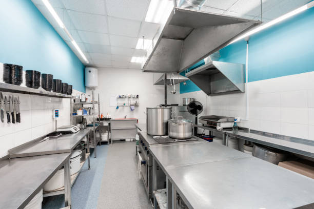 istock Modern restaurant kitchen with stainless steel kitchenware and equipment. Cooking with preparation tables, pans, pots, stoves. 1214428434