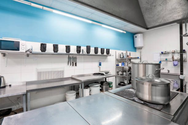 istock Modern restaurant kitchen with stainless steel kitchenware and equipment. Cooking with preparation tables, pans, pots, stoves. 1214428445