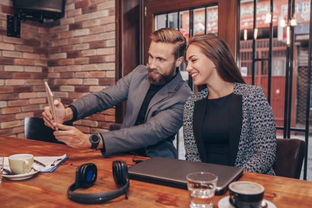 istock Business colleagues taking selfie with digital tablet during coffee break 1214428462