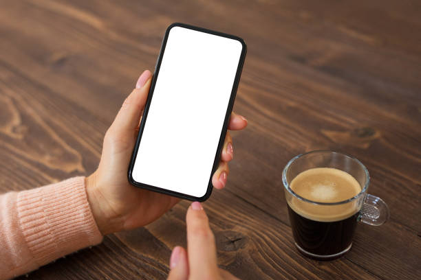 istock Woman using mobile phone. Smartphone mockup with white screen. 1214429044