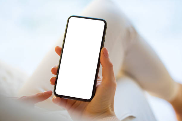 istock Woman holding and using smartphone at home 1214429120